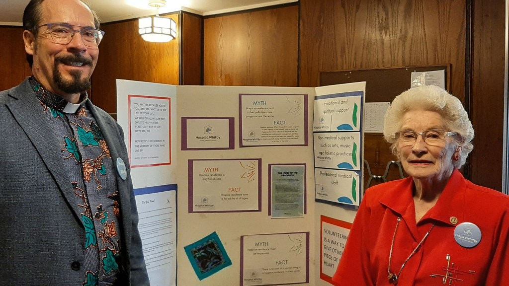 photo of Rev. Alexander and Joyce Marshall in front of the Hospice Durham display