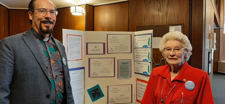 photo of Rev. Alexander and Joyce Marshall in front of the Hospice Durham display